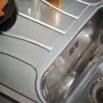 Close-up of the overflow system on the Reginox Diplomat 10 Lux single bowl stainless steel kitchen sink.