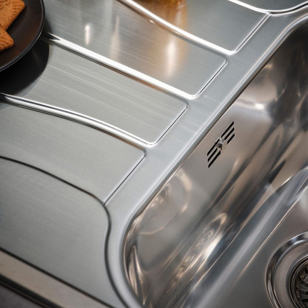 Close-up of the overflow system on the Reginox Diplomat 10 Lux single bowl stainless steel kitchen sink.