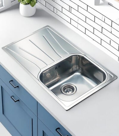 Reginox Diplomat 10 Lux single bowl stainless steel kitchen sink installed in a modern kitchen.