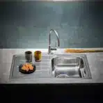 Reginox Diplomat 10 Lux single bowl stainless steel kitchen sink installed in a contemporary kitchen.