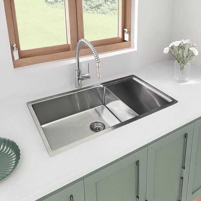 Close view of Carysil Stainless Steel Sink with Drainboard Quadro R10 36x18 in a kitchen environment