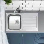 Reginox Centurio 10 single bowl stainless steel kitchen sink installed in a modern kitchen.